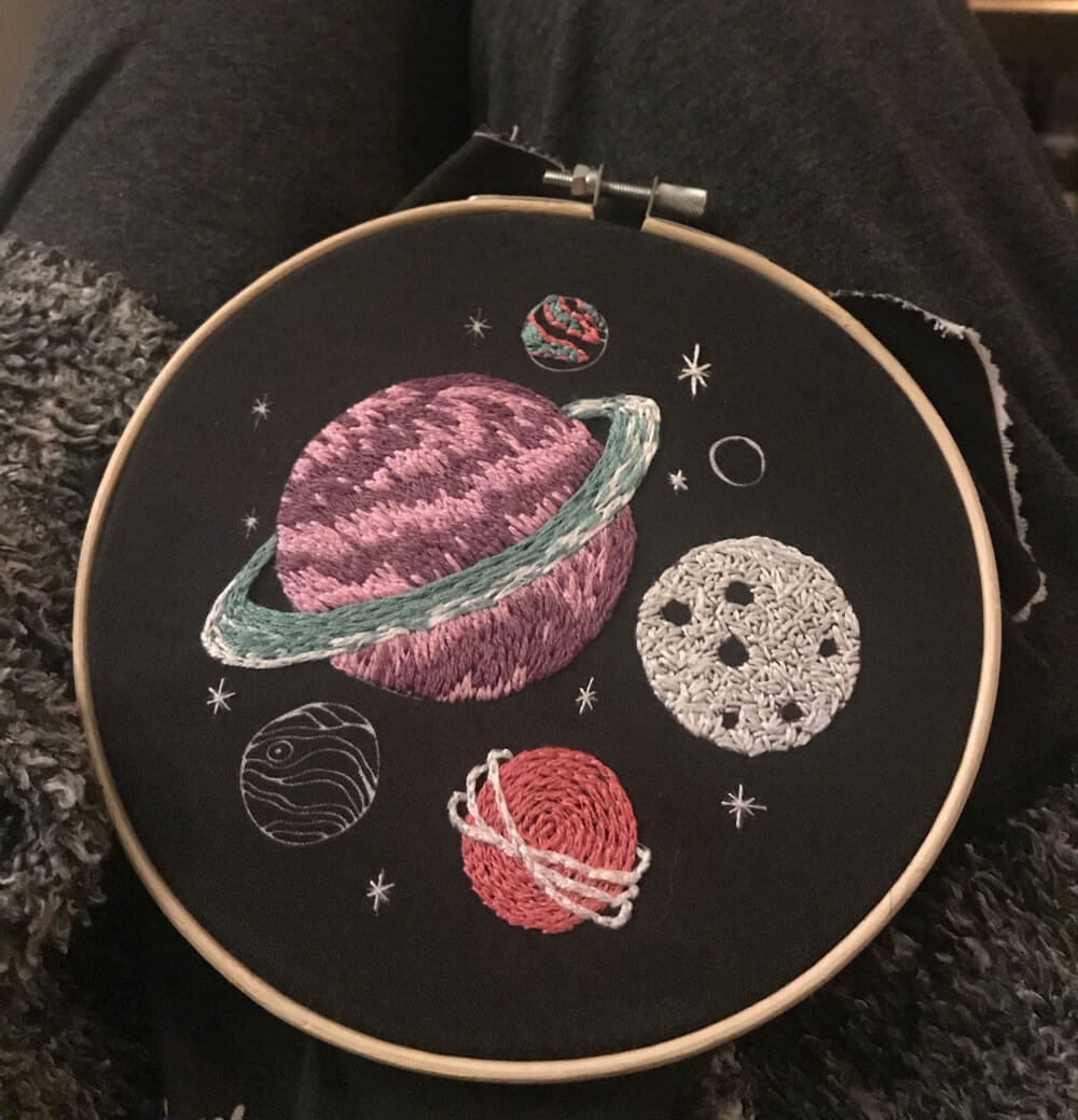 an embroidery hoop of planets